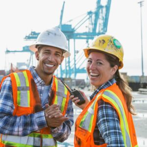 a man and woman wearing safety vests and hardhats